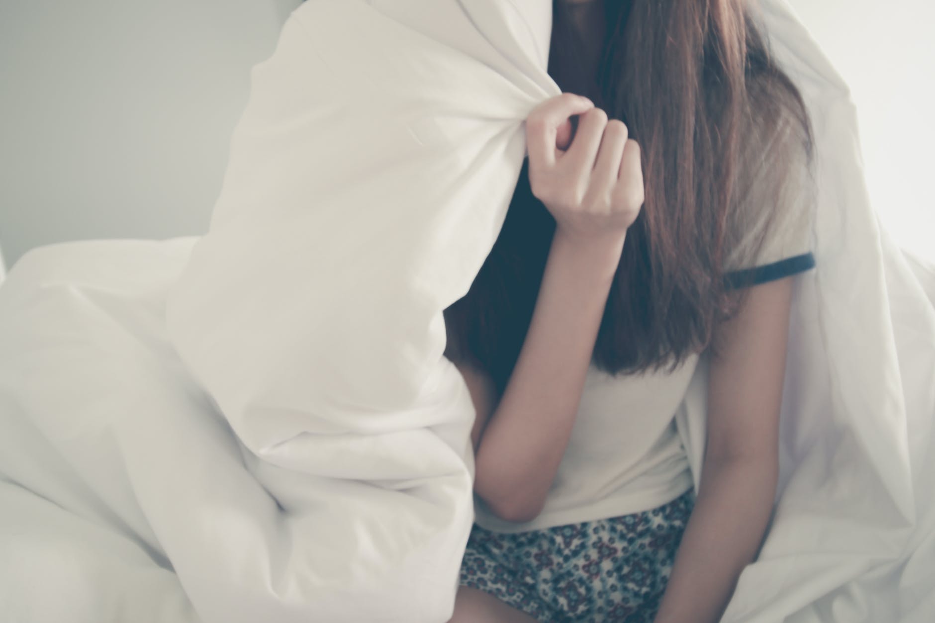 woman with white bedding sheets